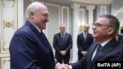 The optics were awkward as Belarusian strongman Alyaksandr Lukashenka warmly greeted the head of the International Ice Hockey Federation, Rene Fasel (right), in Minsk.