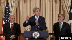 U.S. Secretary of State John Kerry (C) welcomes Afghan President Ashraf Ghani (L) and Chief Executive Abdullah Abdullah for a dinner at the State Department in Washington in March 2015.