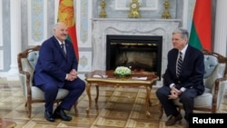 Belarusian President Aleksandr Lukashenko and US envoy John Coale meet in Minsk on December 13.