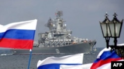 Pro-Russian supporters welcome a flagship of Russia's Black Sea Fleet to Sevastopol .