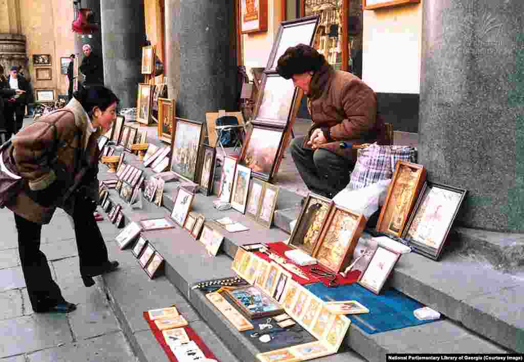 An undated photo of a street vendor selling artwork on Rustaveli Avenue. In independent Georgia, Rustaveli Avenue became a center of shopping and culture, where locals could stroll in the shade of plane trees away from the touristy old town. But with its position in front of the parliament and its potential to effectively shut down Tbilisi's traffic, &ldquo;all protests, regardless of where they begin,&rdquo; ultimately converge on Rustaveli, Chubinidze says. &nbsp;