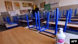 Празна училница и средство за дезинфекција. 