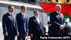 Alyaksandr Lukashenka (right) and his sons (left to right) Viktar, Mikalay, and Dzmitry attend a wreath-laying ceremony marking the 73rd anniversary of the victory over Nazi Germany in Minsk on May 9.