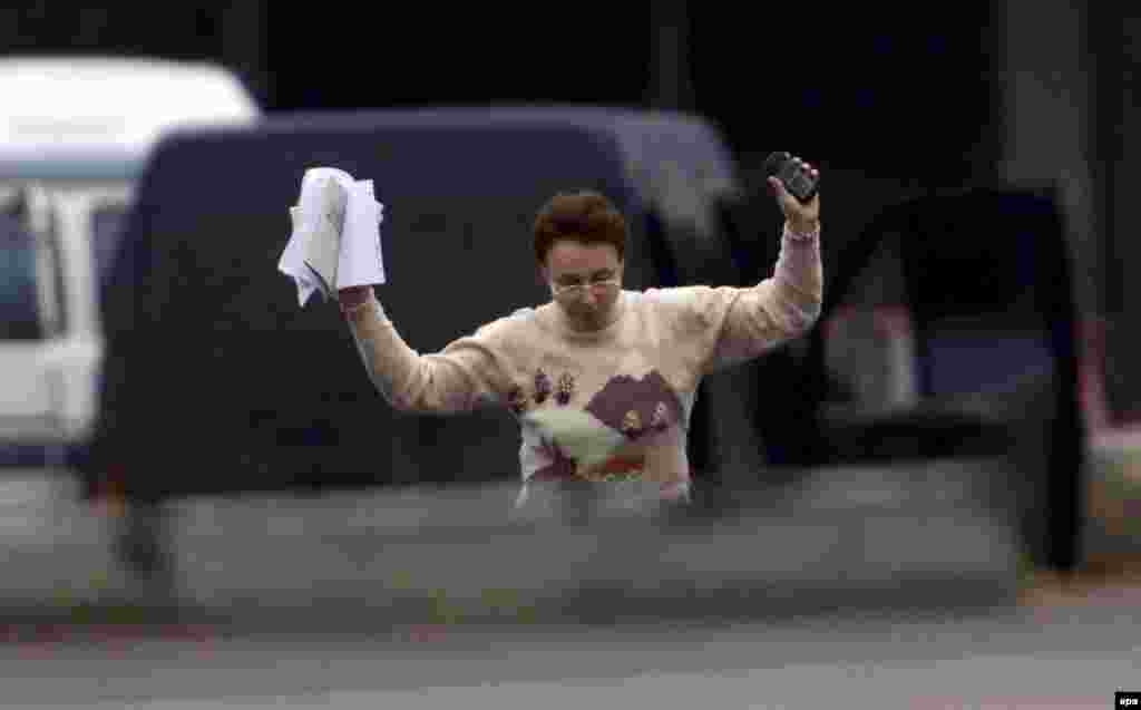 Hostage Maria Shkolnikova leaves the theater with a letter in which the hostages urge Russian President Vladimir Putin to meet the militants' demands and withdraw Russian troops from Chechnya.