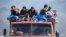 Amenia - Refugees from Nagorno-Karabakh ride in a truck upon their arrival at the border village of Kornidzor, September 27, 2023. 
