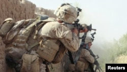 File photo of U.S. Marines return fire during a shootout in Helmand, May 2010.
