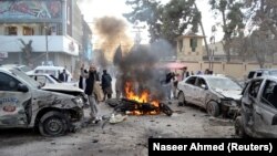 People gather at the site of a suicide bombing in Quetta on February 17.