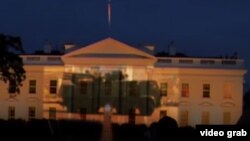 A screen grab from a video posted on YouTube that seemingly shows images of Russian military vehicles projected onto the facade of the White House.
