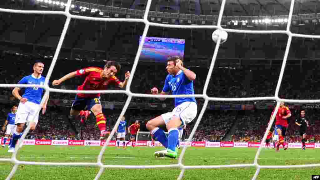 Spanish midfielder David Silva heads the ball to score the first goal of the Euro 2012 final.