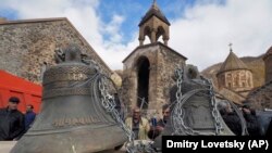 NAGORNO-KARABAKH -- People look at bells removed form the medieval Armenian Dadivank monastery as ethnic Armenians leave the region for Armenia, November 14, 2020.