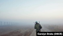 A Tajik border guard patrols the Afghan border, where illegal crossings, robberies, and kidnappings of Tajiks by Afghan drug smugglers are not unusual.