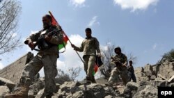 Afghan security forces survey a village in Nangarhar's Kot district after reclaiming it from the Islamic State militants.