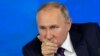 Russian President Vladimir Putin gesticulates during his annual news conference in Moscow on December 23.