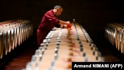 Një punëtor duke u kujdesur për fuçitë me verë në një bodrum vere në Kosovë. Fotografi ilustruese nga arkivi.