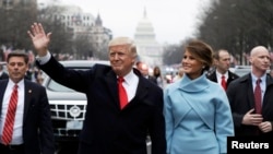 U.S. President Donald Trump and first lady Melania Trump walk during the inaugural parade from the U.S. Capitol in Washington last month. 