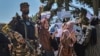 A Taliban fighter stands guard as Afghan women shout slogans during a protest rally near the Pakistani Embassy in Kabul on September 7.