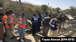 Pakistan security personnel inspect the site of bomb attack, that targeted laborers in Quetta on October 14.