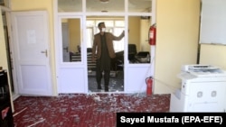 A man inspects the damage caused to his office, near the scene of a suicide bomb blast that targeted the office of Afghan National Directorate of Security (NDS) in Ghazni on May 18.