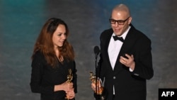 Iranian animator and film director Shirin Sohani (L) and Iranian animator Hossein Molayemi accept the award for Best Animated Short Film for "In the Shadow of the Cypress" onstage during the 97th Annual Academy Awards at the Dolby Theatre in Hollywood, Ca