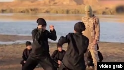 A screengrab from a video purportedly showing young Uyghurs training somewhere in the Middle East and making threats against China. There seems to have been a crackdown on ethnic Uyghurs living in China since the film was released online. 