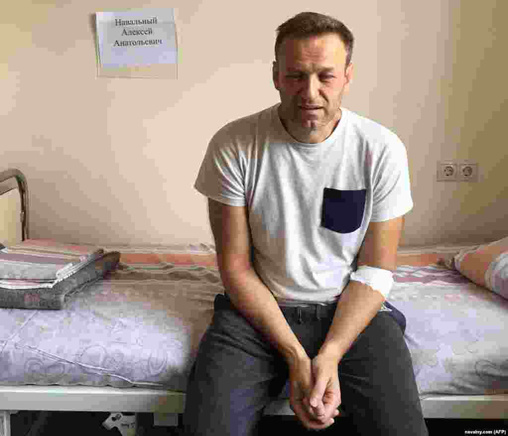 Navalny, his eyes red and puffy, sits on a hospital bed in Moscow on July 29, 2019, after feeling unwell in his Moscow cell while serving a prison term on charges of calling an unauthorized rally. He said he believed he'd been poisoned. Doctors attributed it to an "acute allergic reaction."