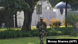 FILE: A Border Security Force (BSF) soldier stands guard outside the Pakistani embassy in New Delhi.