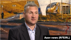 Serhiy Davydyuk, in a photo taken in Kyiv in June 2025, with an image showing the outskirts of his hometown of Nova Kakhovka in southern Ukraine.