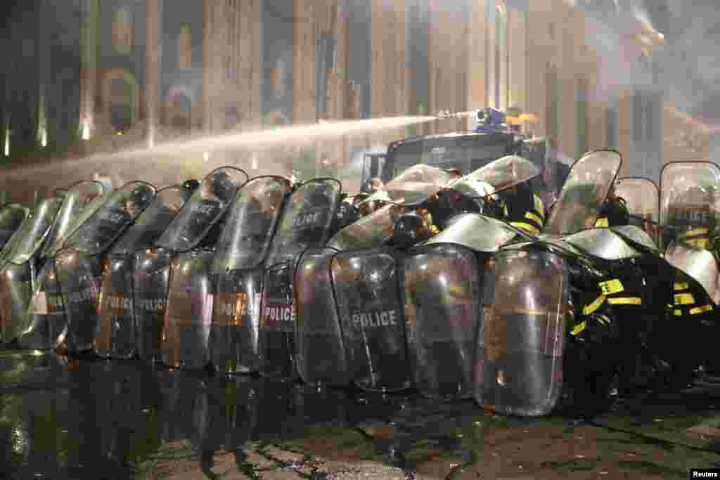 Riot police backed by a water cannon. Georgian authorities reported around 70 people injured overnight, including 39 police officers.&nbsp;