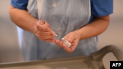 A British nurse prepares a phial of the AstraZeneca COVID-19 vaccine. (file photo)