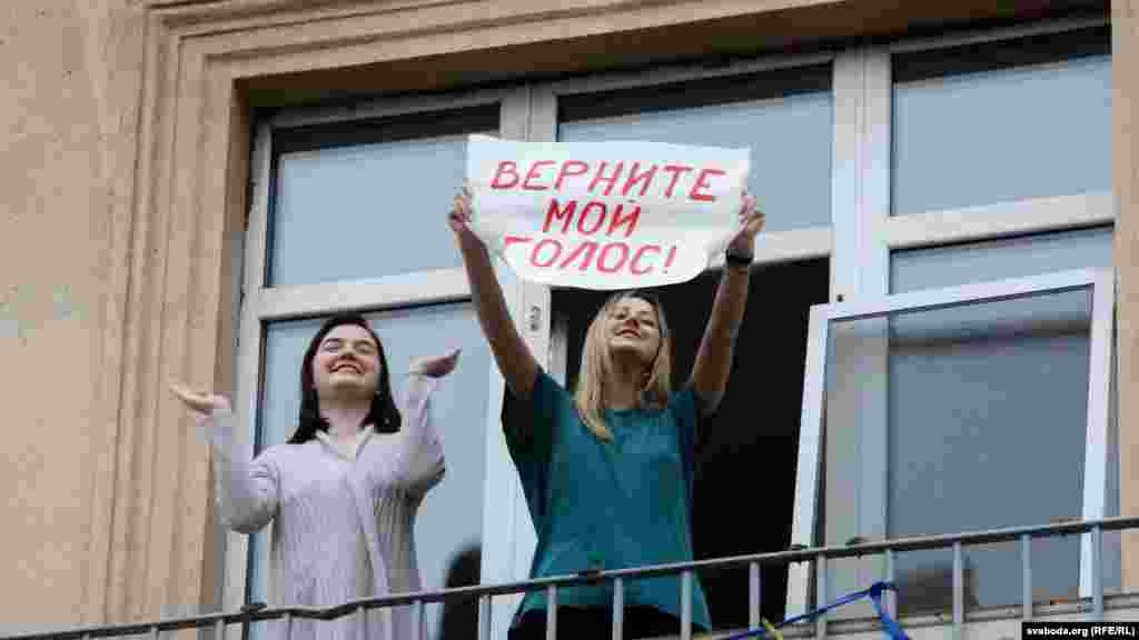 A protester holds up a sign that reads, "Bring back my vote."