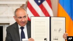 U.S. - Armenian Prime Minister Nikol Pashinian holds a signed trilateral declaration during a ceremony with Azerbaijan President Ilham Aliyev and President Donald Trump at the White House, August 8, 2025.