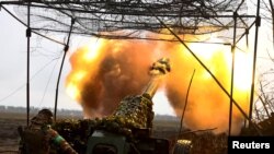 Një ushtar ukrainas duke sulmuar me artileri pozicionet ruse afër Bahmutit. Fotografi nga arkivi. 