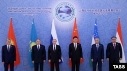FILE: Presidents of the Shanghai Cooperation Organization (SCO) pose at the start of a summit in Tashkent in June.
