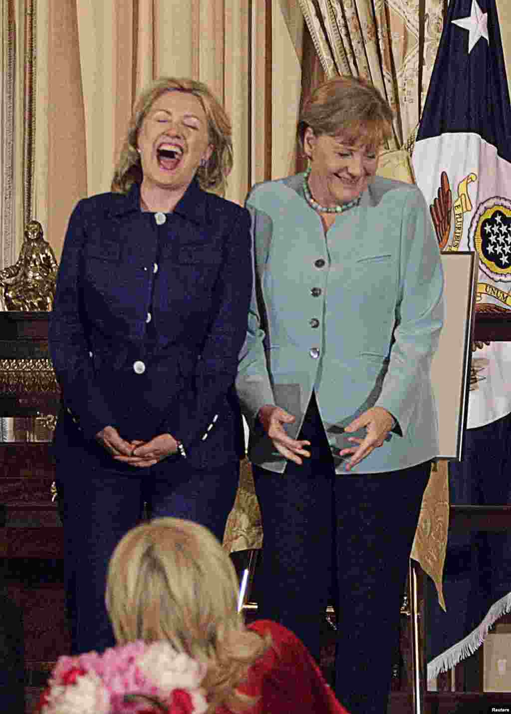 German Chancellor Angela Merkel (right) laughs with Secretary of State Clinton during a luncheon held in Merkel's honor at the State Department on June 7, 2011.