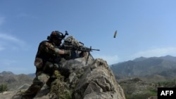 FILE: An Afghan soldier during an ongoing operation against Islamic State (IS) militants in the eastern Nangarhar province in April 11.