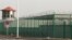 CHINA -- A guard tower and barbed wire fences surround an internment facility in the Kunshan Industrial Park which has previously been revealed by leaked documents to be a forced indoctrination camp in Artux in western China's Xinjiang region, December 3,