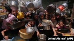 Palestinezët e uritur në pritje të ndihmave në Gazë